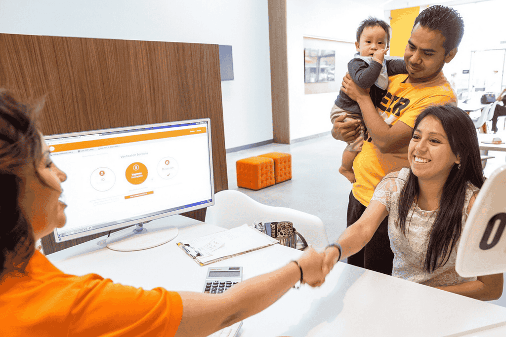 Woman shaking hands with customer and family