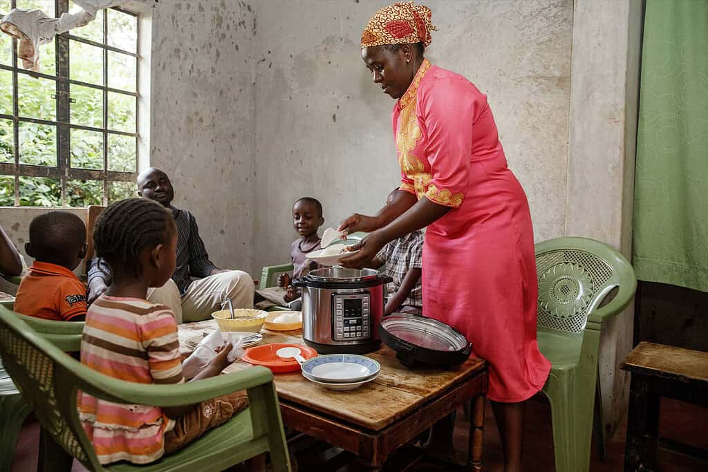 An African mum serves her family dinner.