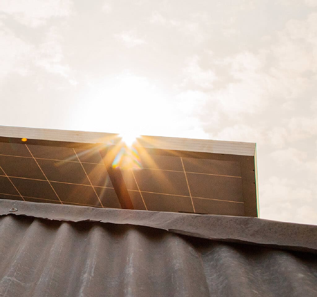 A solar panel on top of a building receiving sun light
