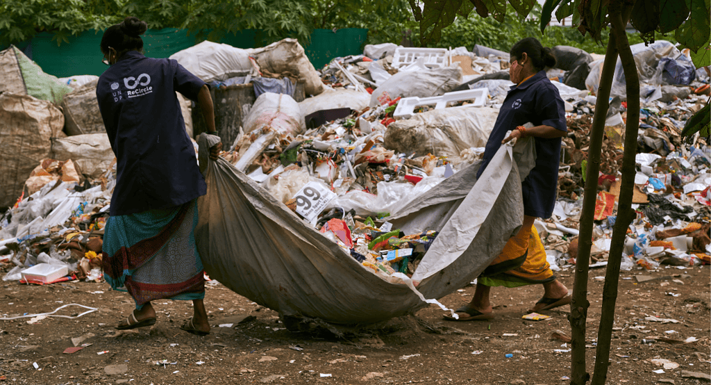 workers carry waste as a part of a waste processing program