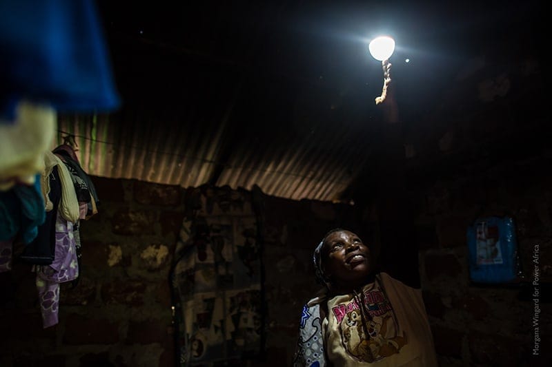 MURANG'A, KENYA: June 1, 2015 - Nancy Wambui, 45, saved for 3 months to buy d.light solar home system, a personal power grid, for her home with the help of her local village women's group. Before the d.light system her husband, Charles Macharia, 51, and her used kerosene lamps which were costly to fuel and painful to their eyes. The first night they had it, their daughter, Paris (17), stayed up until 1am studying. Before she was number 6 in class and now she is number 2. Photo by Morgana Wingard