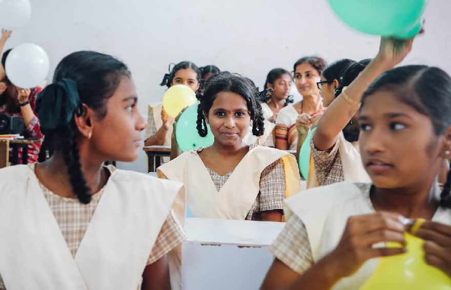 A classroom full of girls preparing for class in India