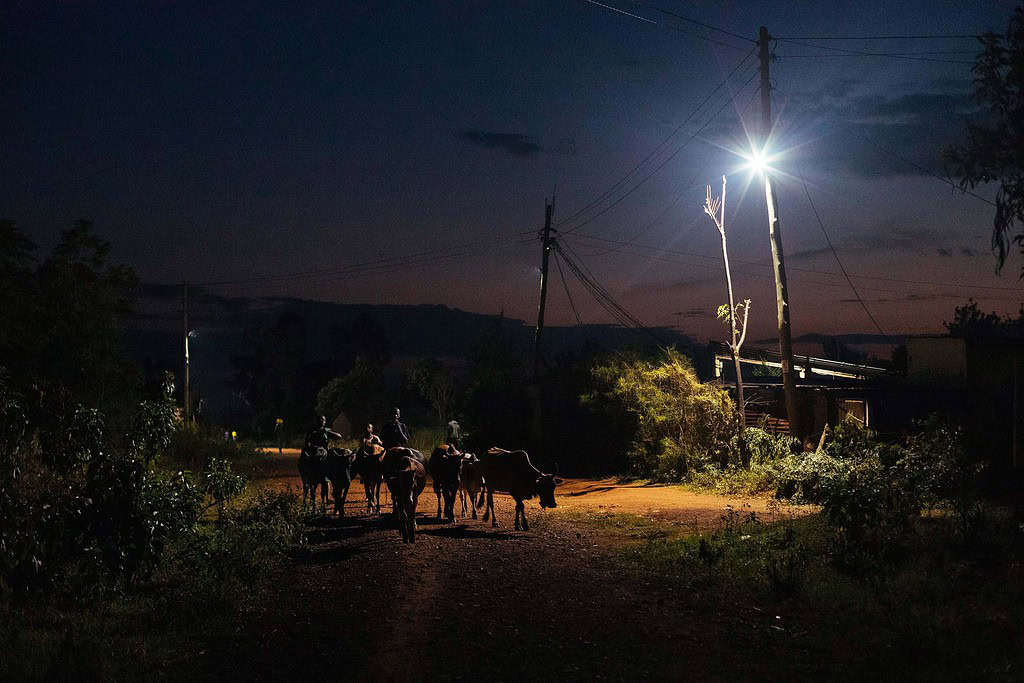 Rural East African road at night lit with a light powered by a mini-grid array