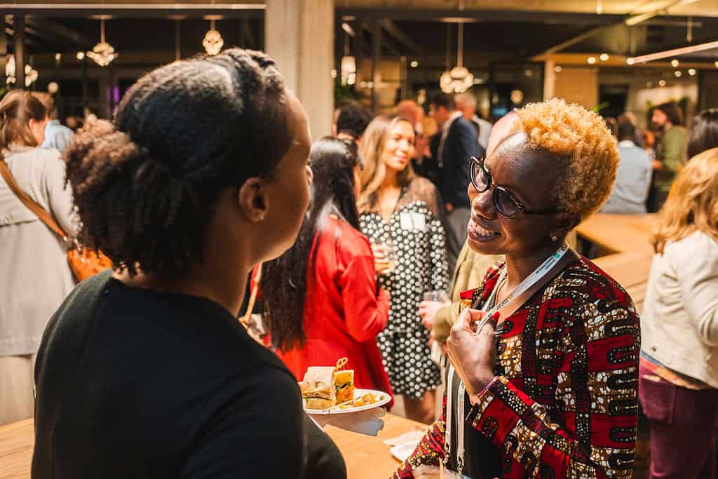 Two women share a conversation at networking event
