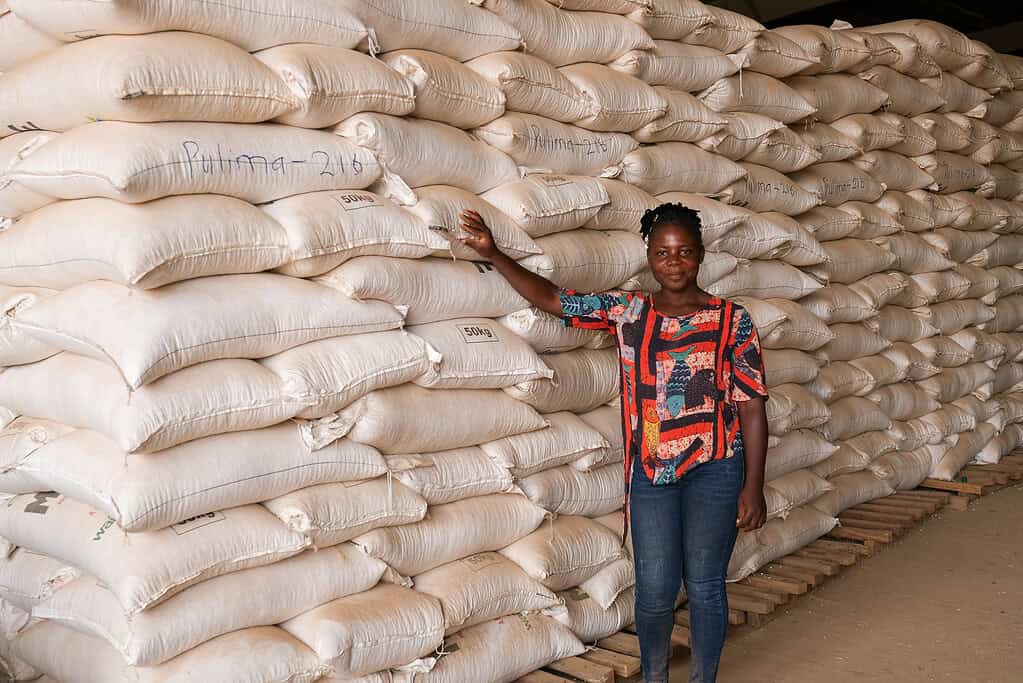 Woman in front of rice bags