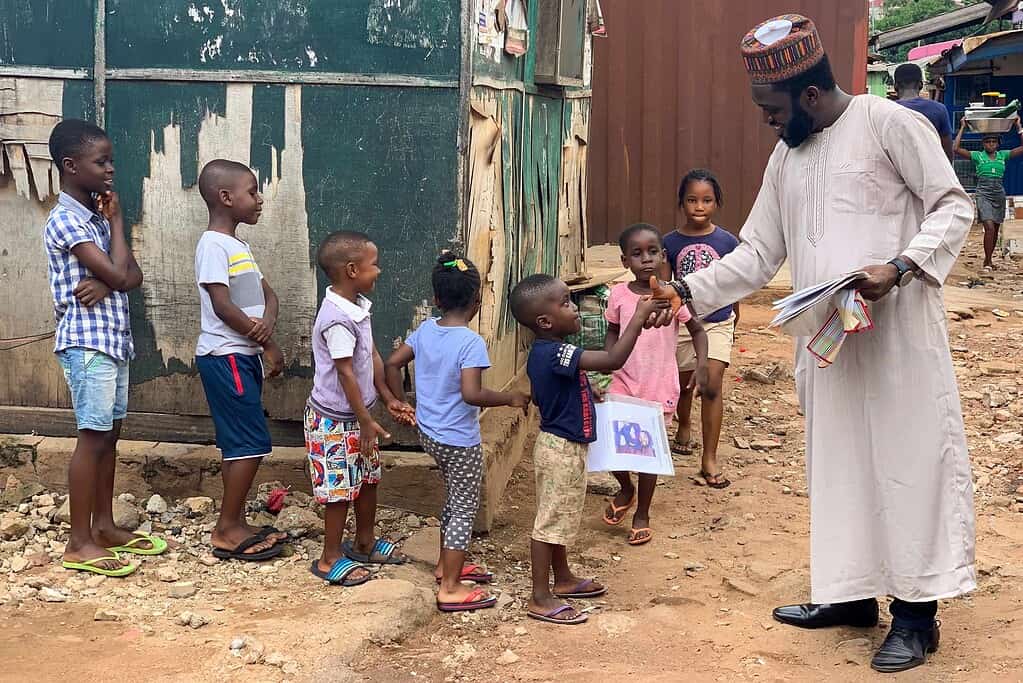 Dr. Tosan Mogbeyiteren, founder and CEO of WeMUNIZE, meeting with young children in a Nigerian neighborhood