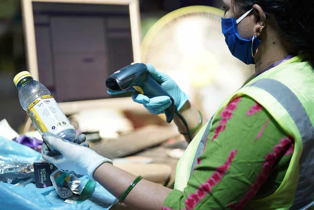Bintix employee scanning waste products in processing facility
