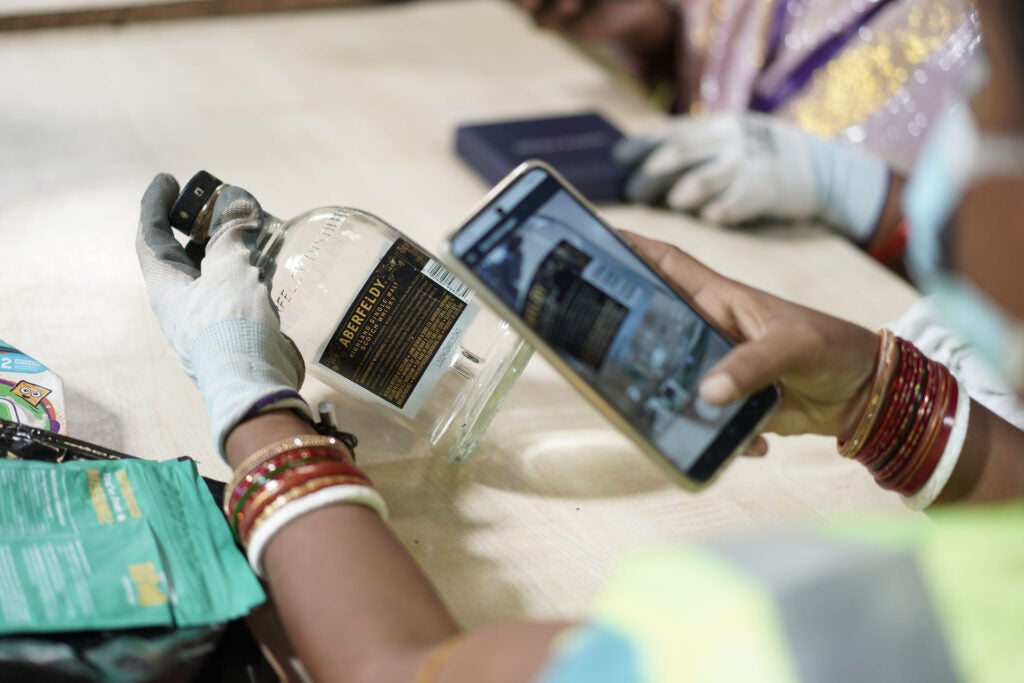 Bintix employee scanning waste products in processing facility
