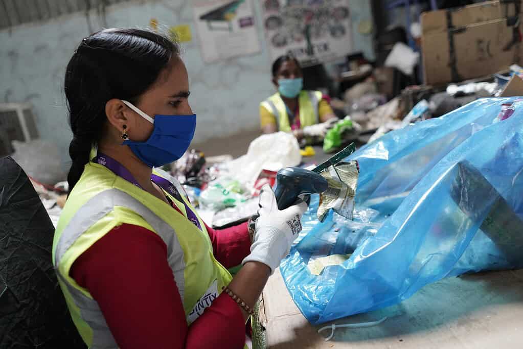Bintix employee scanning waste products in processing facility