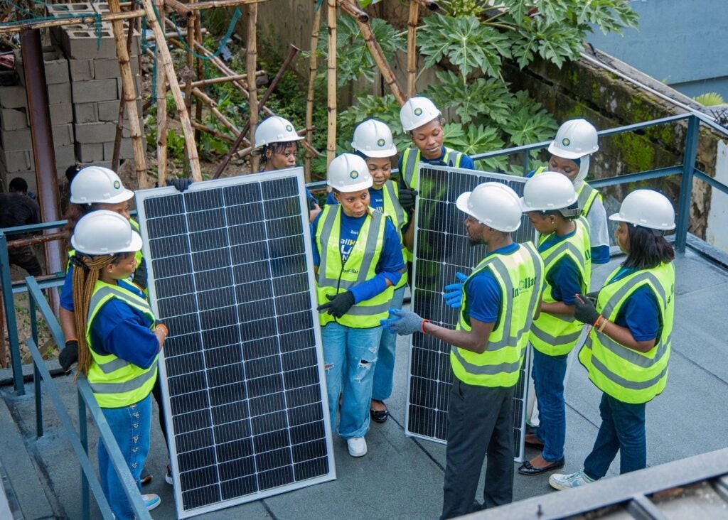 Instollar employees working with solar panel