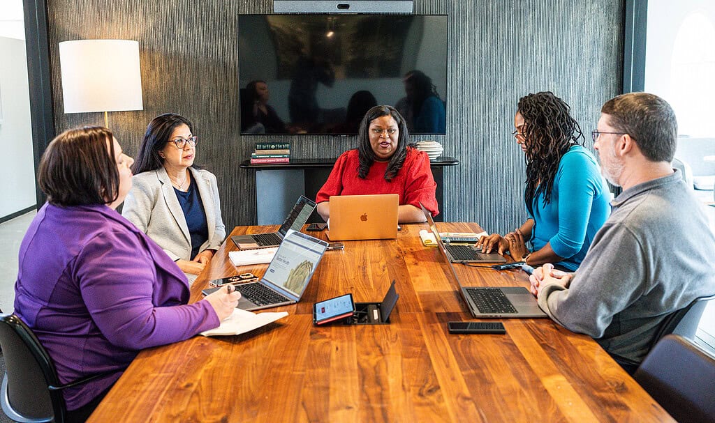 Workers conduct a meeting