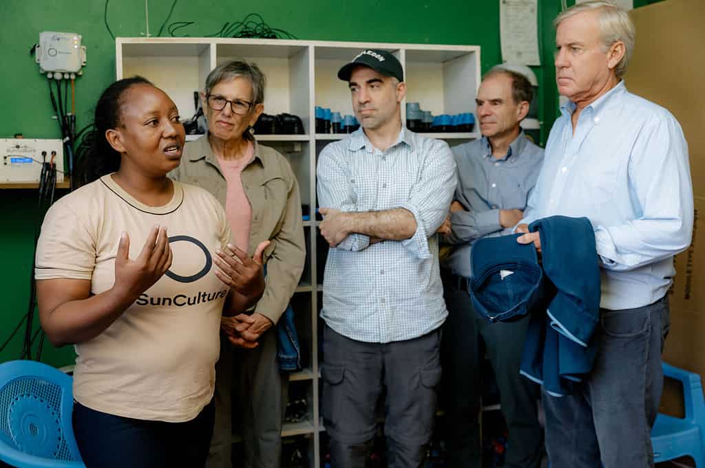 Investors intently listen to SunCulture employee at a SunCulture regional office in East Africa
