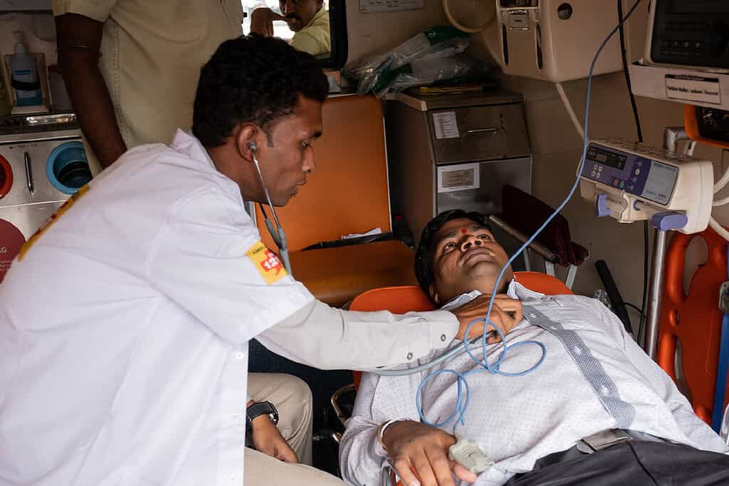 Medical professional conducts examination in the back of a Ziqitza ambulette in India