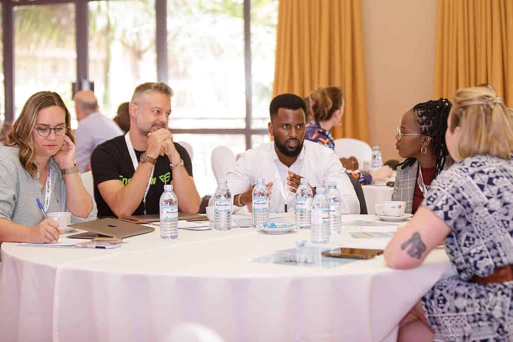 Attendees of the Acumen Energy Summit discussing energy access