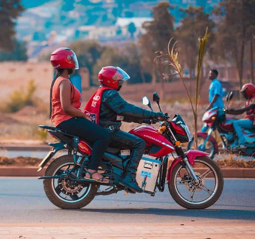 Two people ride an Ampersand electric motorcycle in East Africa