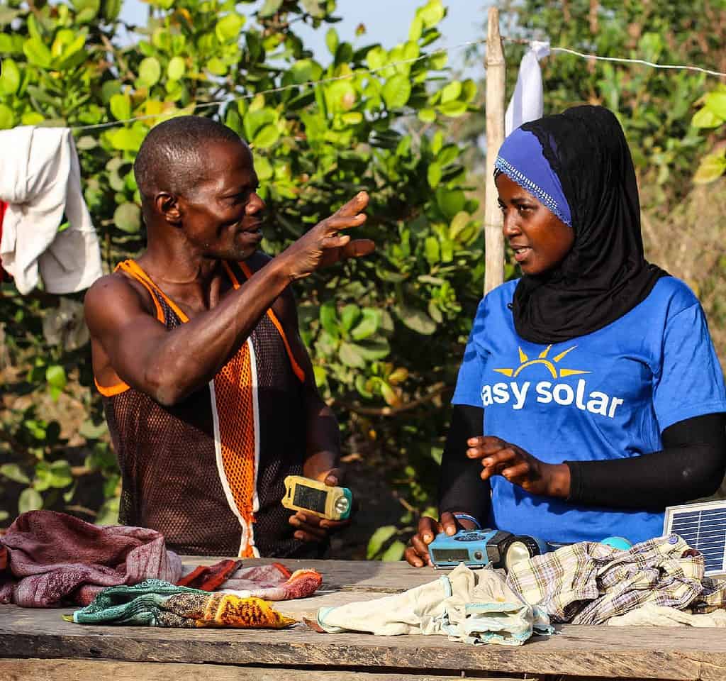 Man speaks with Easy Solar representative in his yard