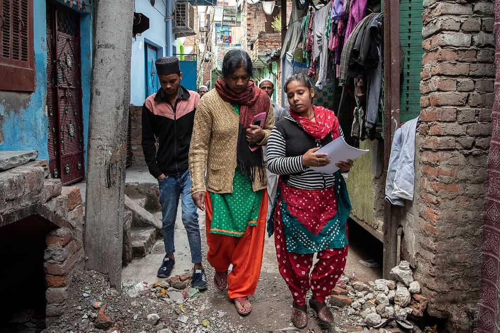 Haqdarshak team members Preeti Singh (C) and Beenu Kumari (R) walk around in the slum area of Dilshad garden in New Delhi, India, March 6, 2020. Photo by Saumya Khandelwal