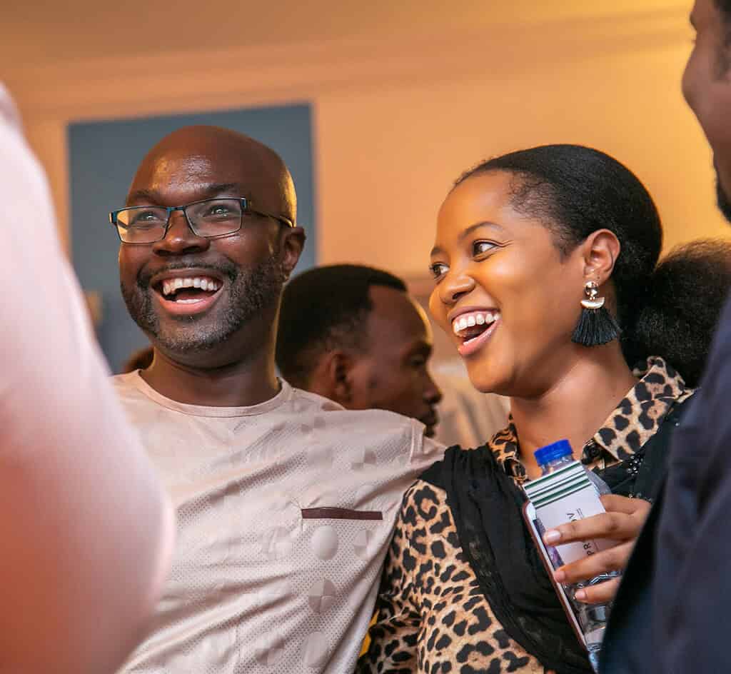 Man and Women smile cheerfully at networking event