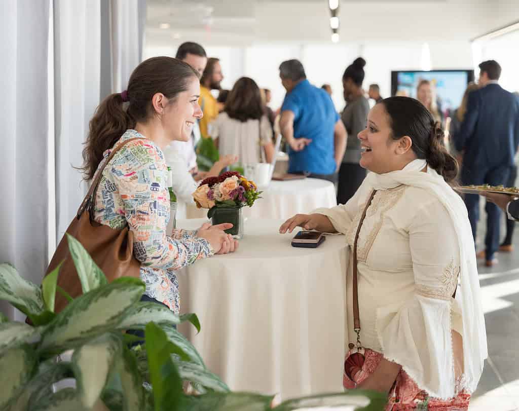 Acumen fellow and S4S Technologies founder Nidhi Pant speaks with woman at event