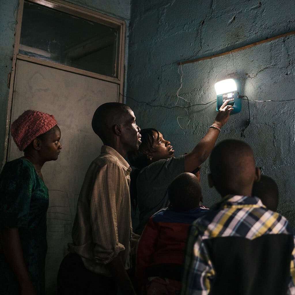 People looking at light on wall