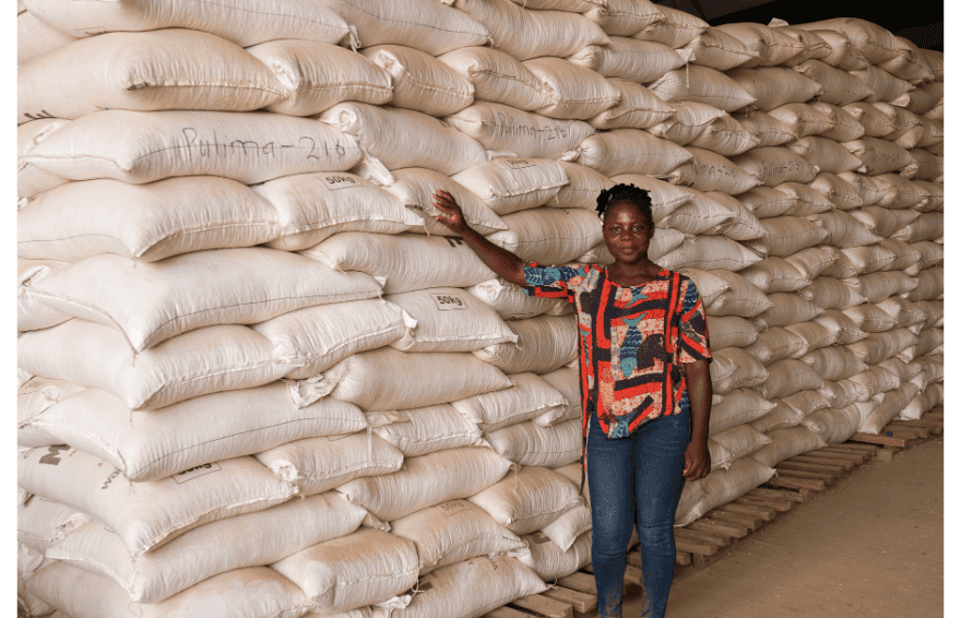 Woman in front of bags of materials