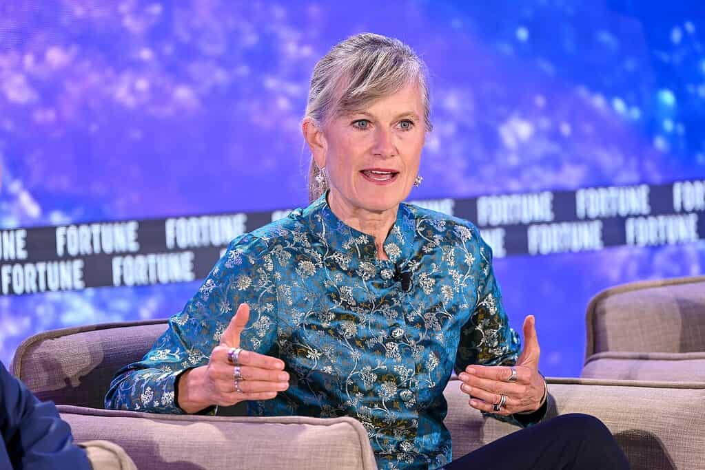 Jacqueline Novogratz is speaking at a Fortune event, sitting on a stage with a blue background.